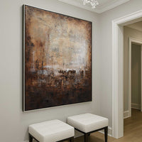 Abstract painting on a wall in a room with white stools.