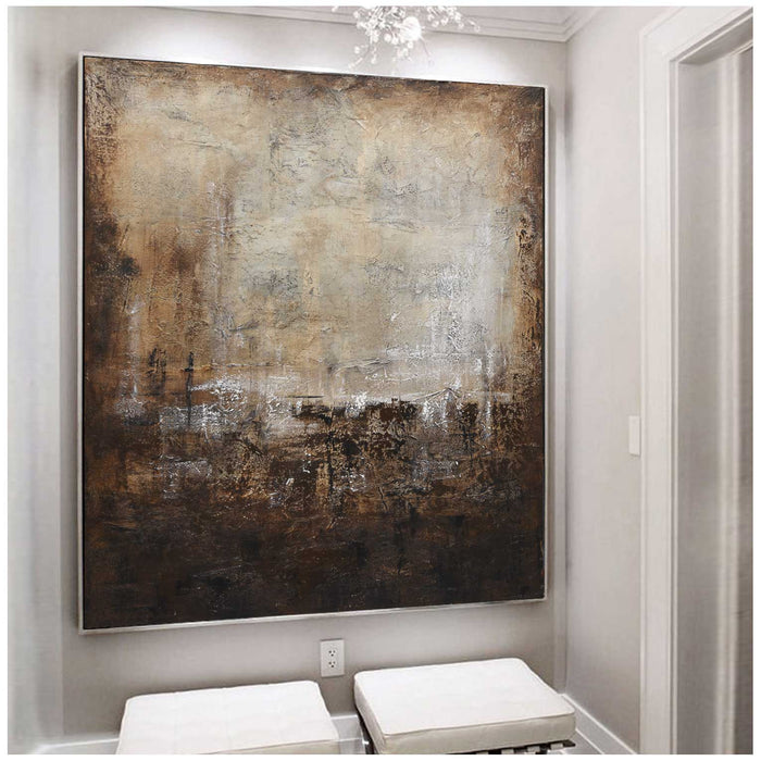 Abstract painting on a wall in a room with white furniture
