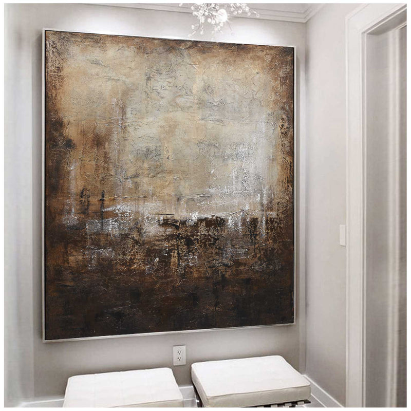 Abstract painting on a wall in a room with white furniture
